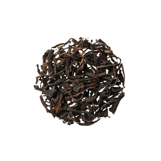 Dry black tea leaves on a white background